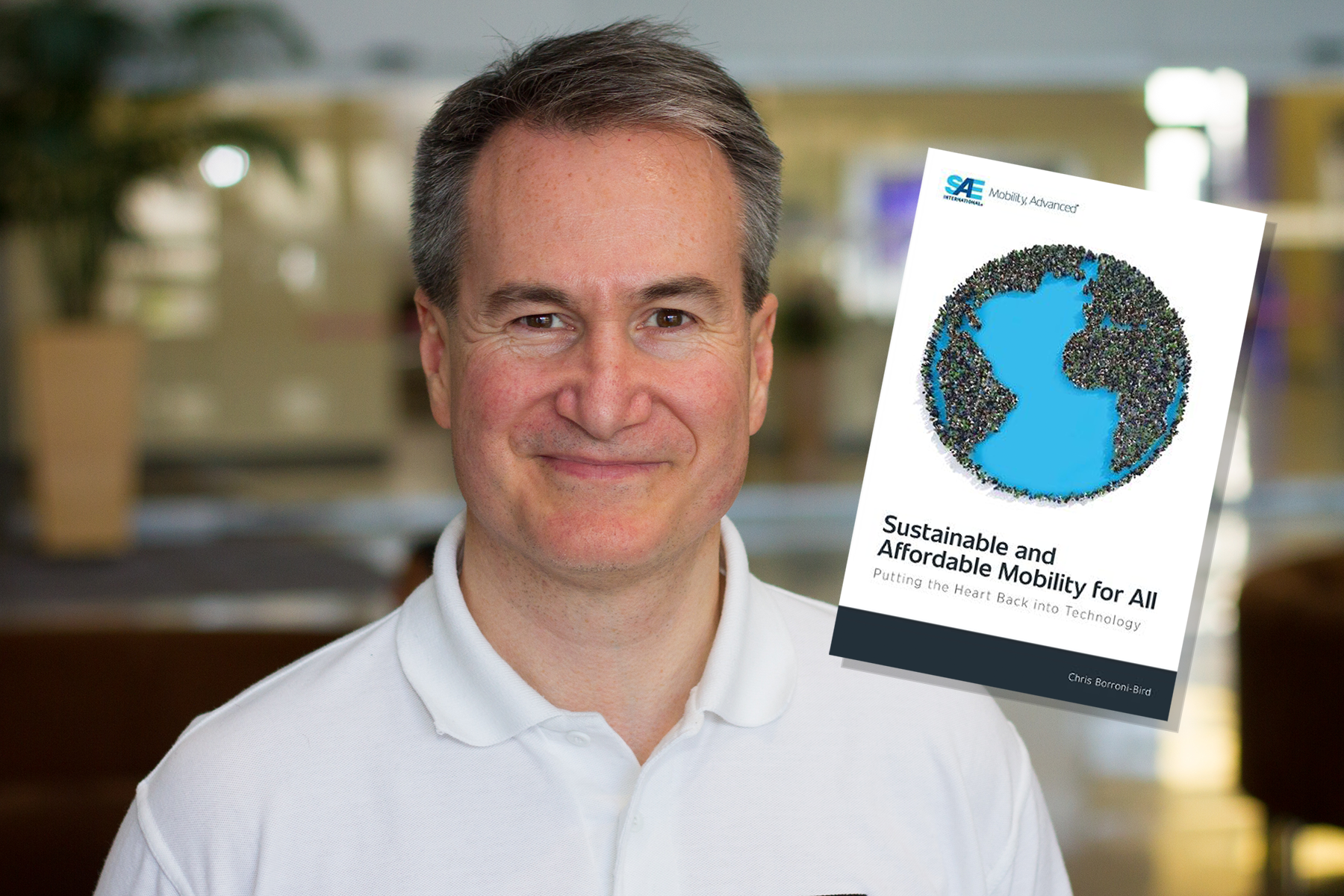 Portrait of Dr. Borroni-Bird with the cover of his book