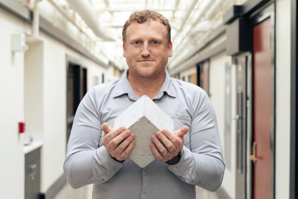 “Roman concrete to me is fascinating: It’s still standing after all this time and constantly repairing,” Admir Masic says, pictured here holding a Roman-inspired, self-healing concrete cube. 