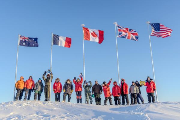 Scientists participating in Operation Ice Camp 2024 display flags representing their countries. 